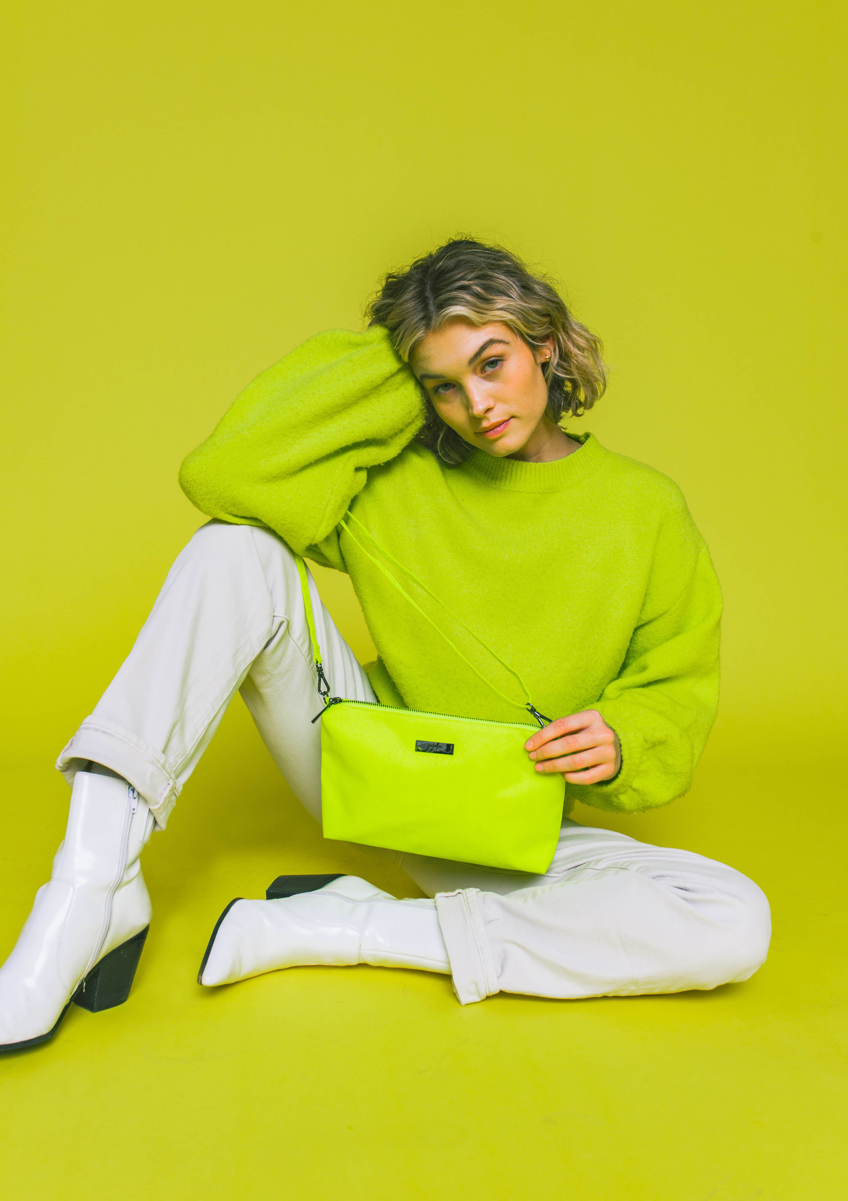 Neon Yellow Be Quick Crossbody Bag Worn by Woman wearing Matching Colored Sweater