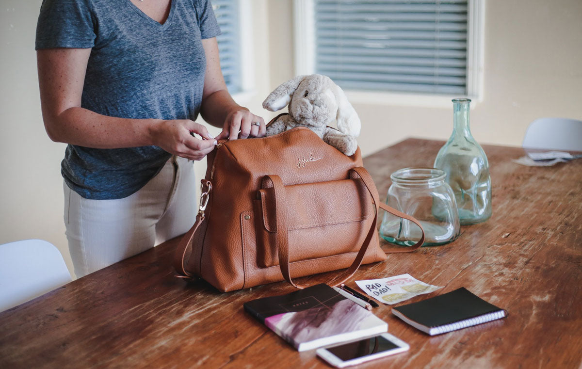 Woman packs her bag with everyday essentials