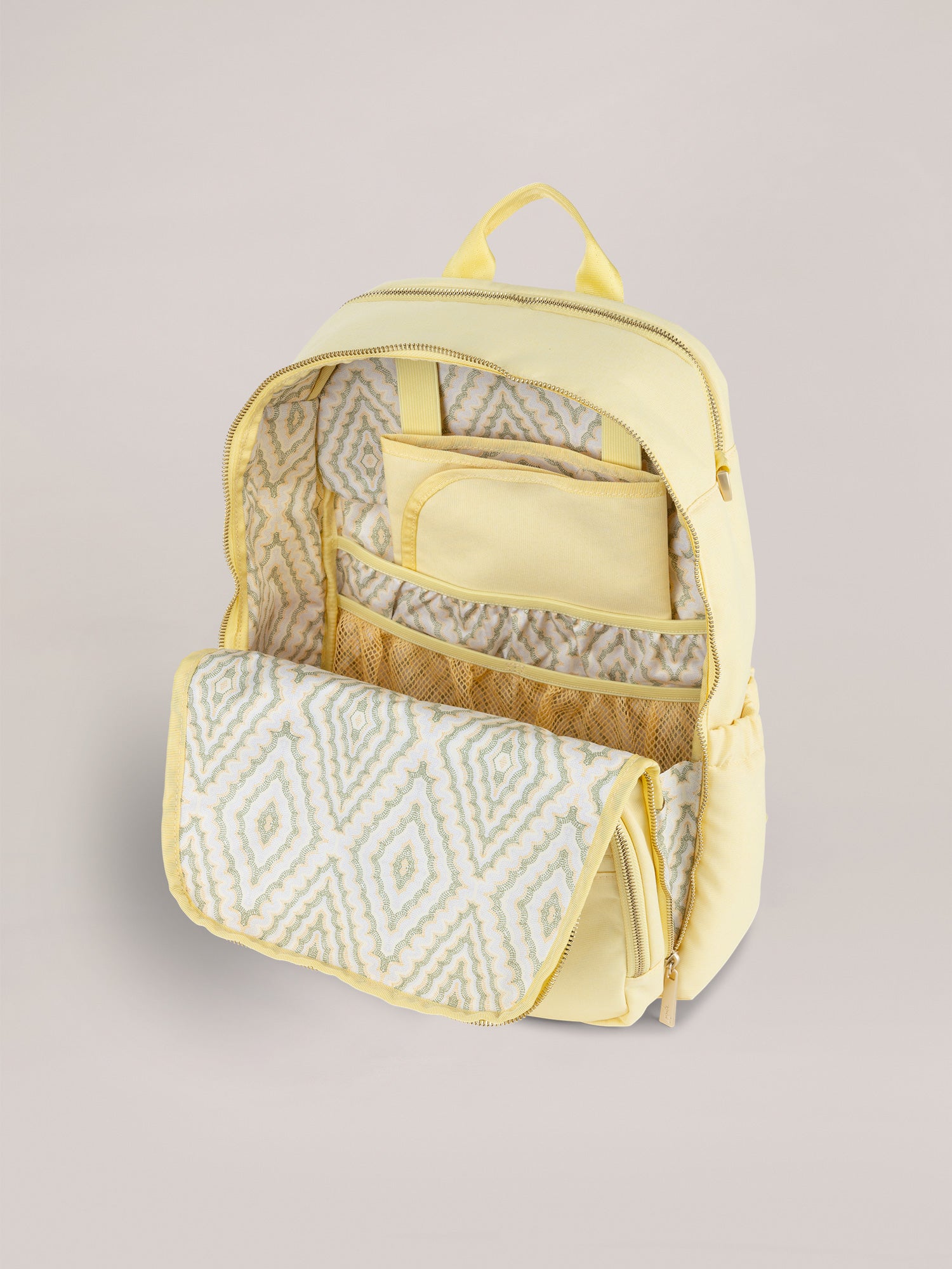 Light Yellow Zealous Backpack Diaper Bag Open Quarter Angle View with Changing Pad.