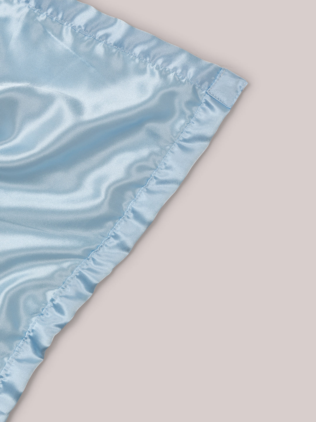 Mr. Happy security blanket showing reverse satin side