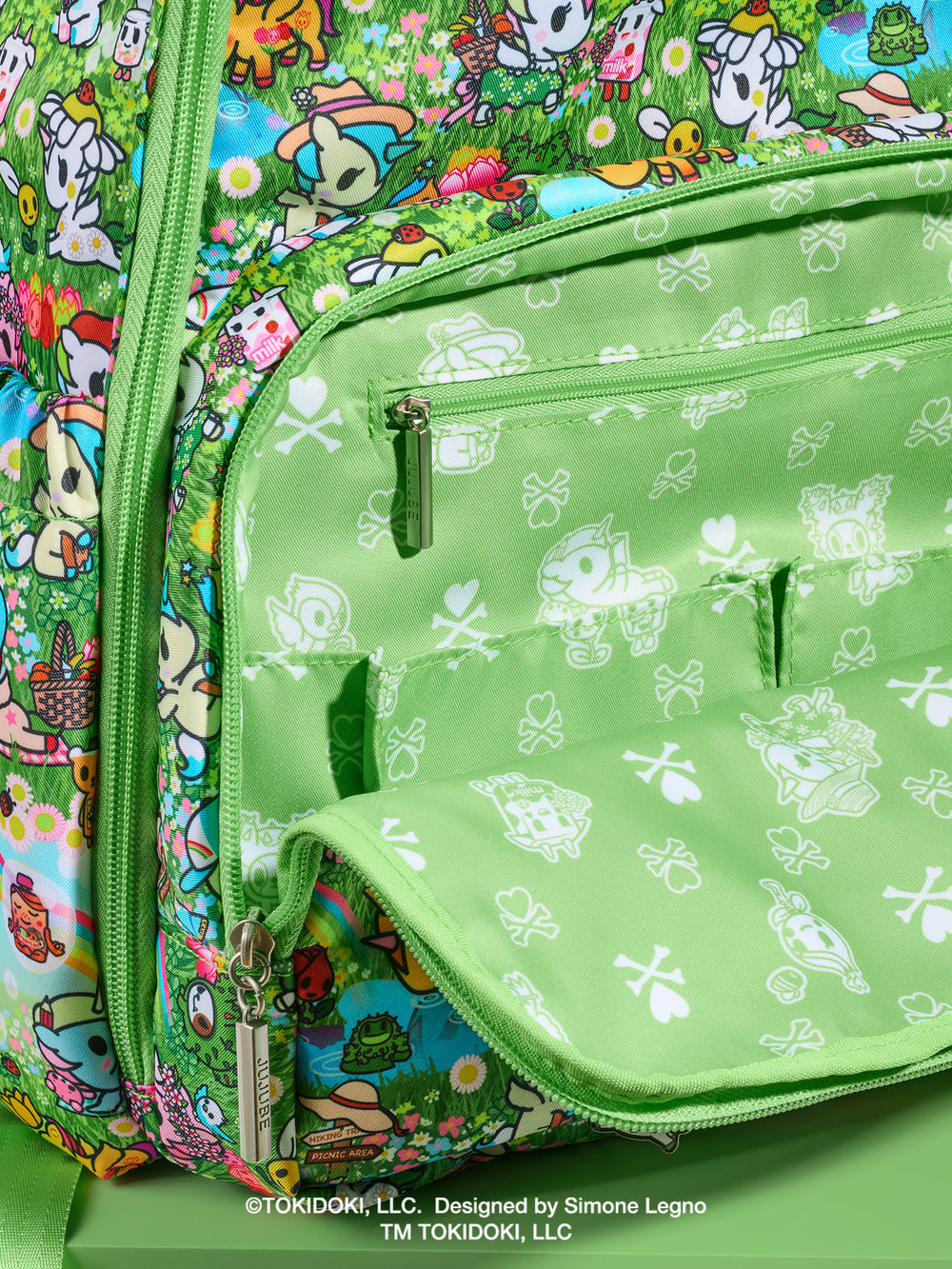 tokidoki x JuJuBe Zealous Diaper Bag Backpack in Meadow Blooms – close-up of front zippered pocket area