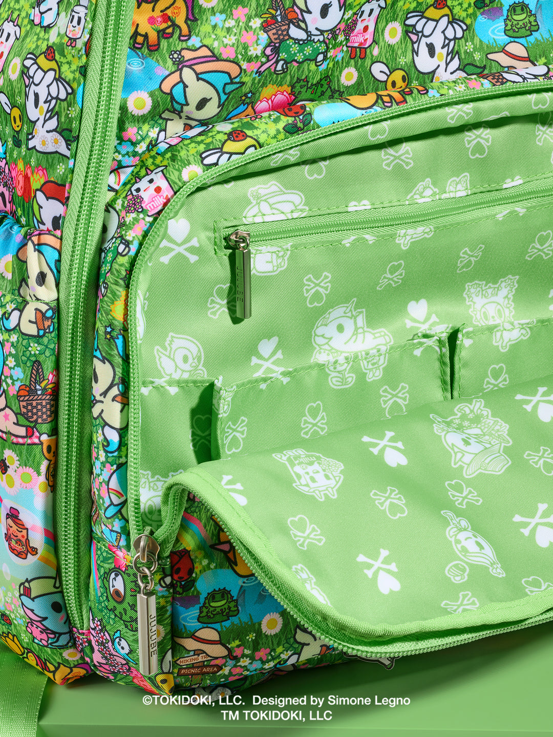tokidoki x JuJuBe Zealous Diaper Bag Backpack in Meadow Blooms – close-up of front zippered pocket area