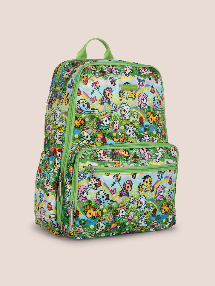 tokidoki x JuJuBe Zealous Diaper Bag Backpack in Meadow Blooms – front view showcasing the vibrant green print featuring tokidoki characters, fairies, and botanical florals