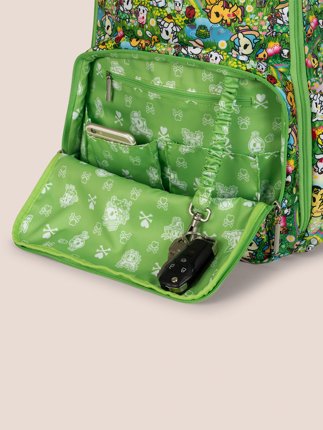 tokidoki x JuJuBe Zealous Diaper Bag Backpack in Meadow Blooms – front view with the large front pocket fully unzipped, revealing interior slip pockets and key leash
