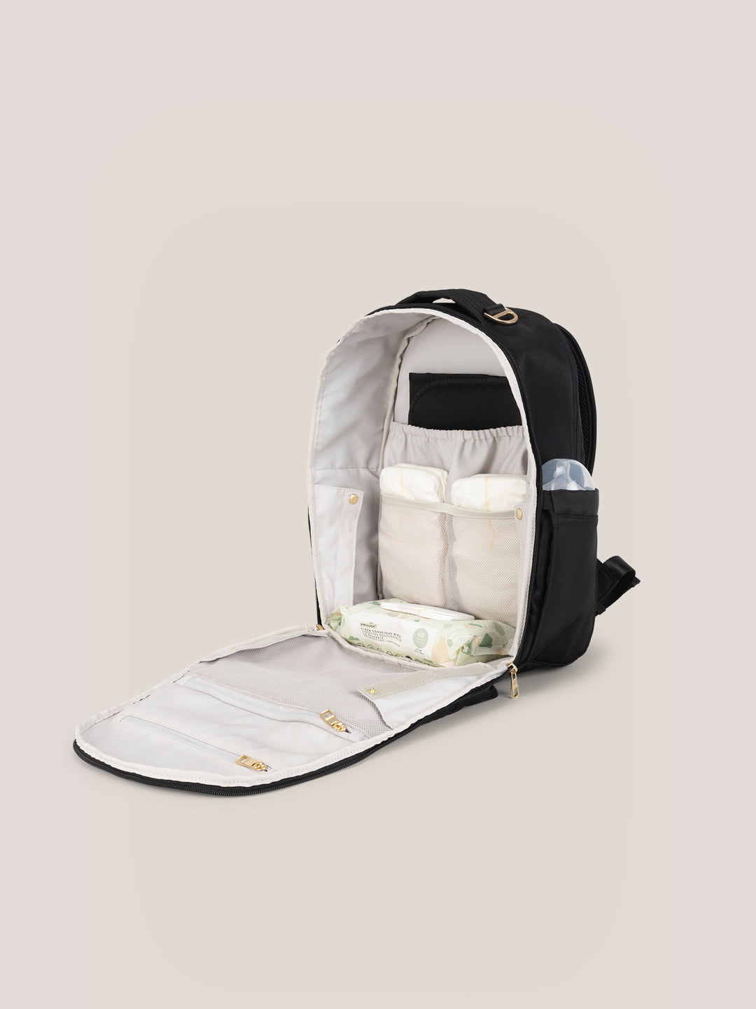 JuJuBe Classic Diaper Backpack in Black – interior view revealing organized compartments, laptop sleeve, dedicated diaper pockets, and included cushioned changing pad