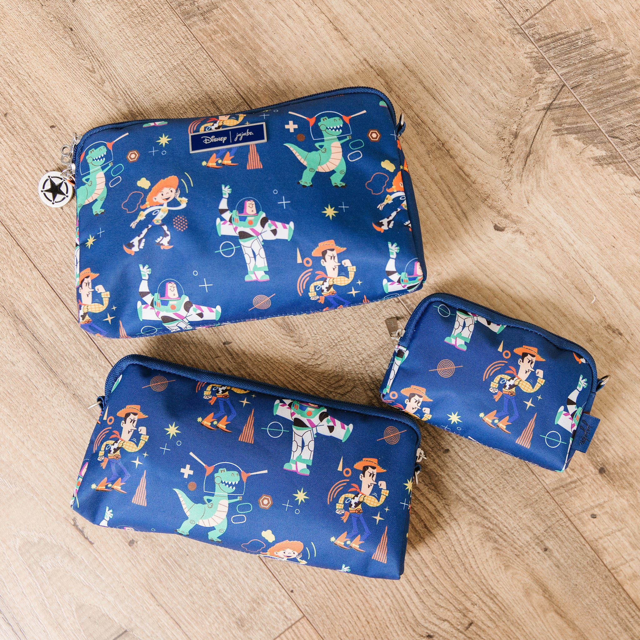 Featuring Woody, Buzz, and all their friends from Toy Story and Disney Pixar's Dr. B.F.F on a dark navy blue background, lifestyle shot (3 Pack-Small-Medium-Large-Organization-Bags).